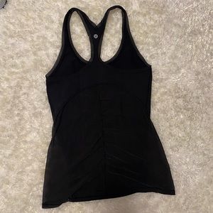 Black Lulu lemon workout tank with mesh detailing in back